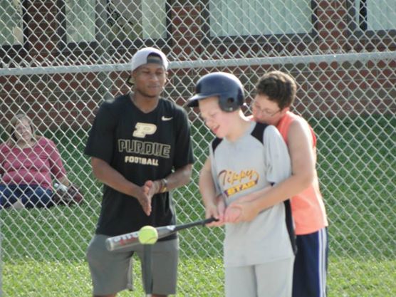 Brittany helping Samuel bat.