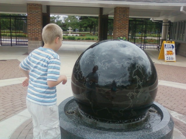 Samuel likes the spinning world at Columbian Park Zoo.
