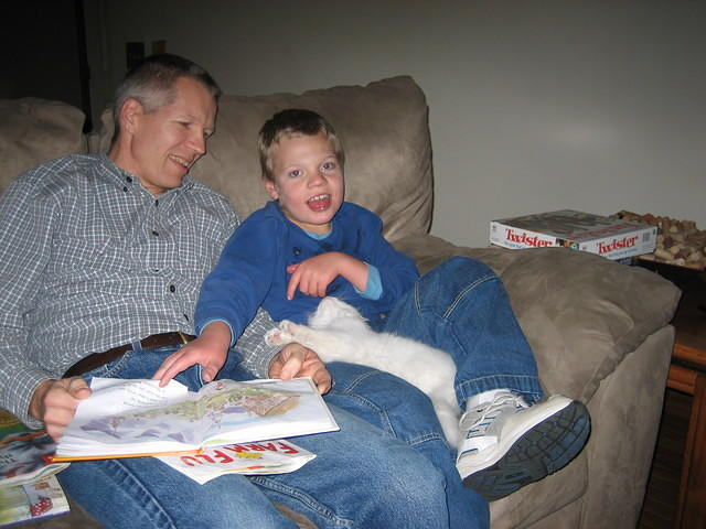 But the cat keeps trying to get his attention!