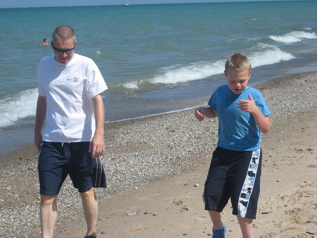 Dan and Samuel walking on the beach.