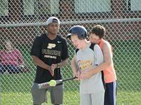 Brittany helping Samuel bat.