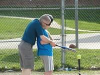Dan helping Samuel bat.
