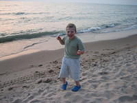 Samuel likes walking in the sand.