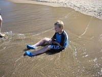 Samuel liked the waves coming up over him.